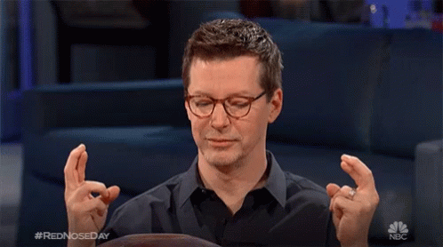 Man Crossed Fingers On Red Nose Day GIF