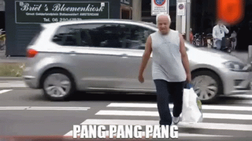 Man Crossing Street in Front of Briel's Bloemenkiosk