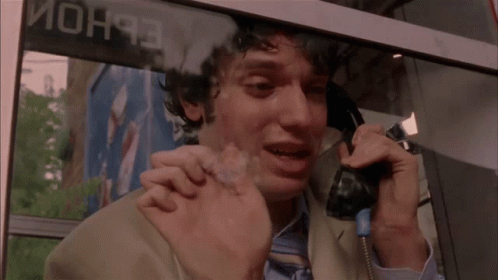 Man Crying on Phone in Front of Mon93 Sign
