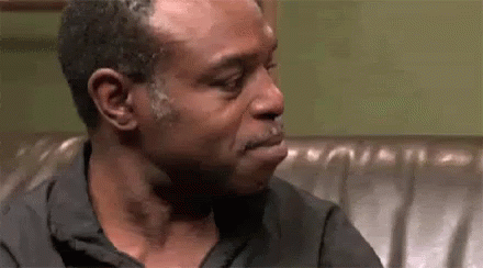 Man Crying While Sitting on Couch