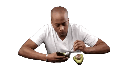 Man Cutting Avocado With Fork