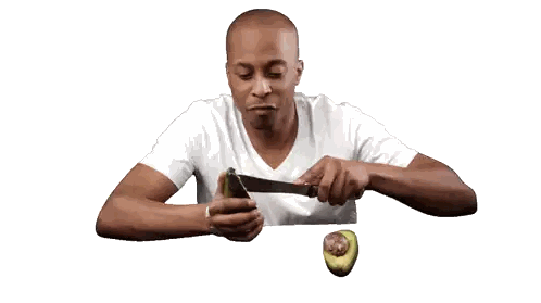 Man Cutting Avocado With Knife