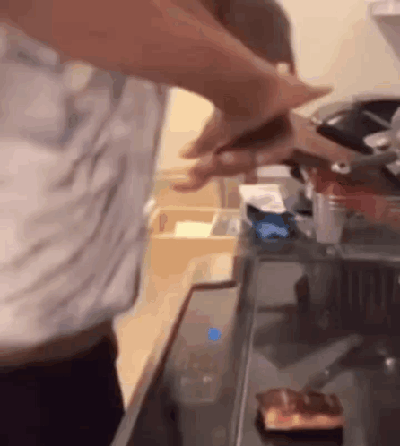 Man Cutting Meat on Stove Top