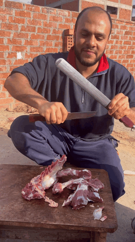 Man Cutting Meat with Large Knife