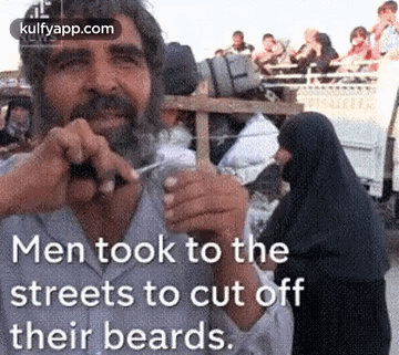 Man Cutting Off Beard with Scissors
