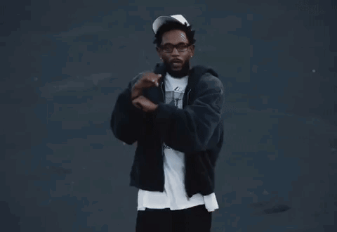 Man Dancing in Black Jacket and White Hat