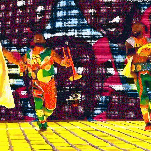 Man Dancing In Colorful Outfit Holding Trumpet GIF