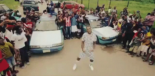 Man Dancing in Crowd, Another in Adidas Shirt