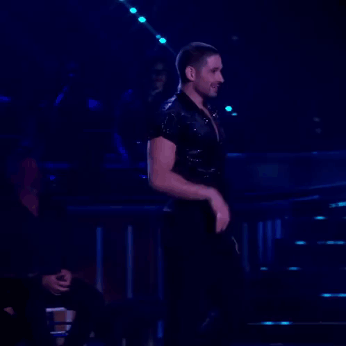 Man Dancing in Dark Room