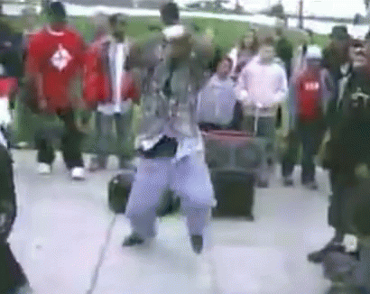 Man Dancing In Front Of Crowd On Street GIF