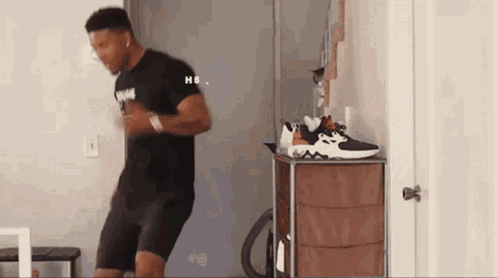 Man Dancing in Front of Dresser With Shoes