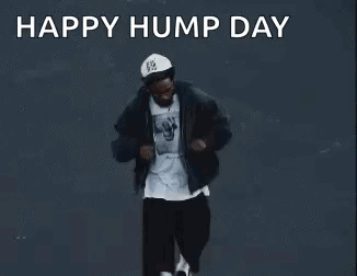 Man Dancing in Front of Happy Hump Day Sign
