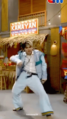 Man Dancing in Front of Kamayan Sign