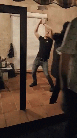 Man Dancing In Front Of Mirror In Living Room GIF