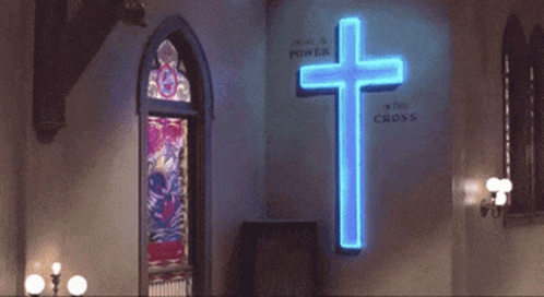 Man Dancing in Front of Neon Cross Saying We Are a Power