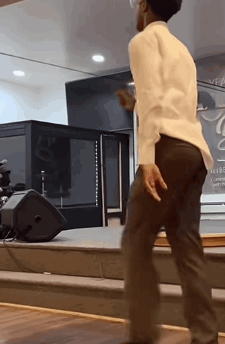 Man Dancing in Front of Veal Sign