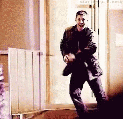 Man Dancing In Hallway In Front Of Door GIF
