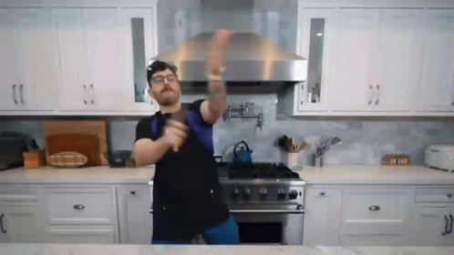 Man Dancing in Kitchen With Sword