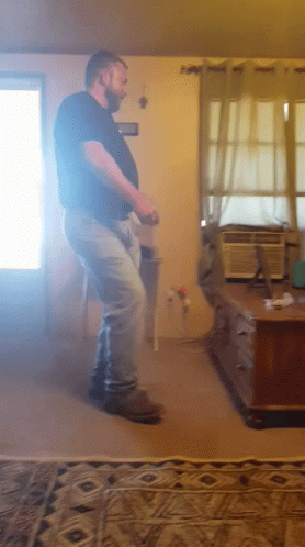 Man Dancing in Living Room With Air Conditioner