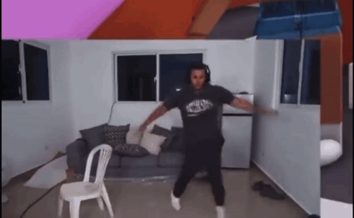 Man Dancing in Living Room With Chair and Couch