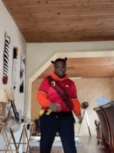 Man Dancing in Red Adidas Shirt