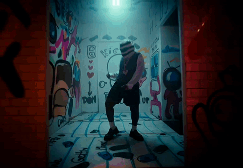 Man Dancing In Room With Kiss Graffiti GIF