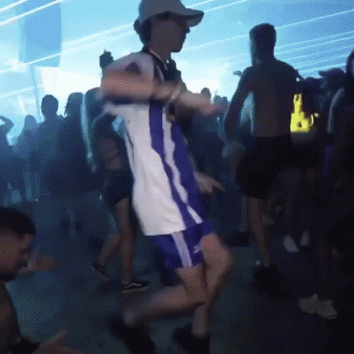 Man Dancing in White Shirt and Blue Shorts