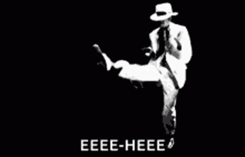Man Dancing in White Suit and Hat