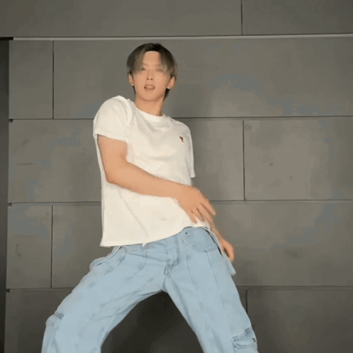 Man Dancing in White T-Shirt and Blue Jeans