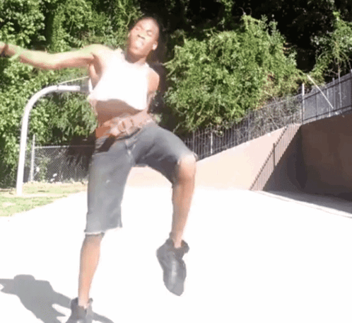 Man Dancing in White Tank Top and Black Shorts
