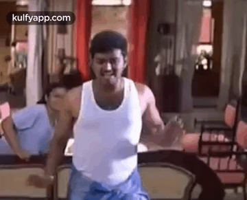 Man Dancing in White Tank Top