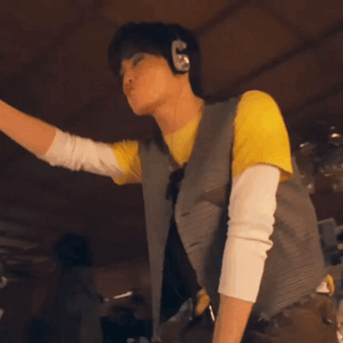 Man Dancing in Yellow Shirt and Brown Pants