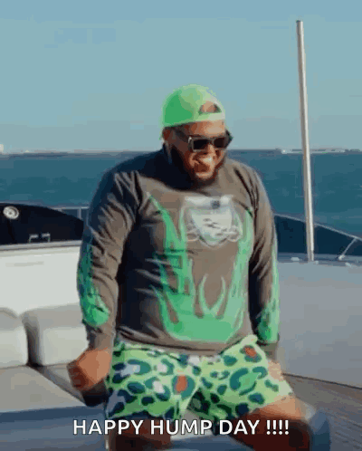 Man Dancing On Boat In Green Hat And Shorts GIF