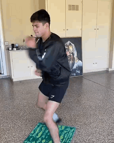 Man Dancing on Mat in Garage