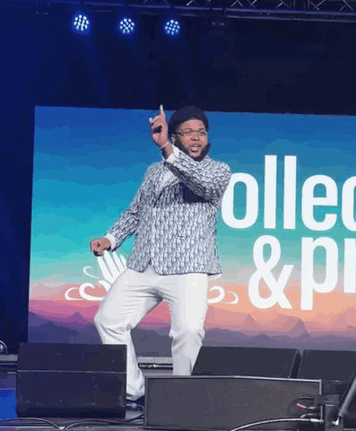 Man Dancing On Stage In Front Of Collect & Pi Screen GIF