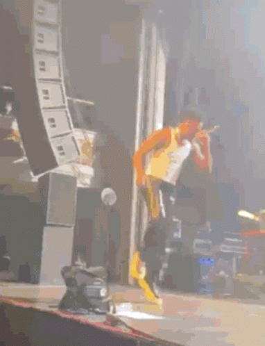 Man Dancing on Stage in Front of Keyboard