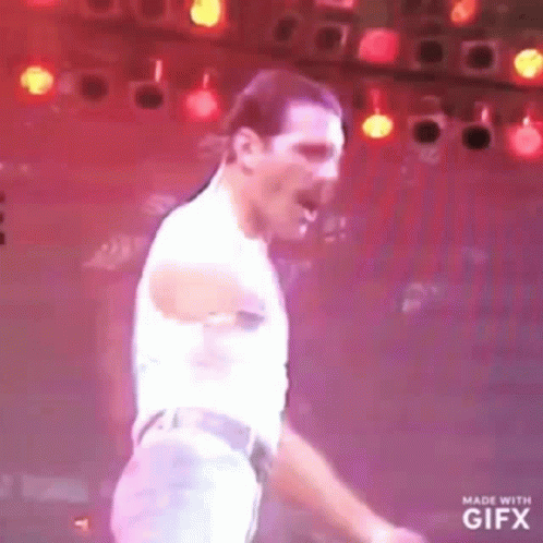 Man Dancing on Stage in Front of Red Lights
