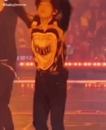 Man Dancing on Stage in Yellow Shirt