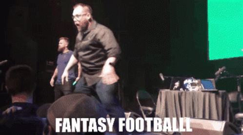 Man Dancing on Stage With Fantasy Football