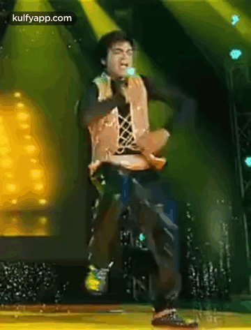 Man Dancing on Stage with Microphone