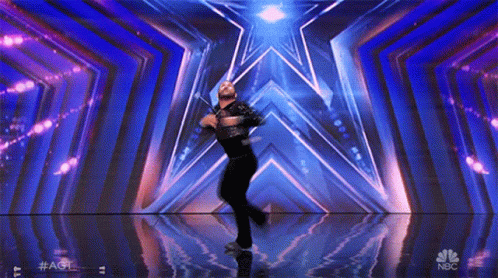 Man Dancing on Stage With NBC Logo