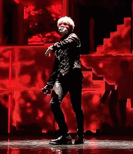 Man Dancing On Stage With Red Wall GIF