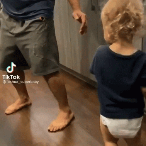 Man Dancing With Baby in Diaper