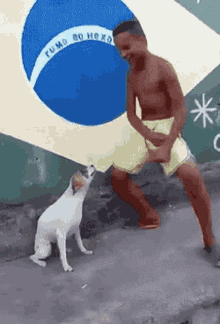 Man Dancing With Dog in Front of Brazilian Flag