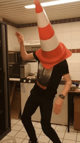 Man Dancing With Traffic Cone on Head