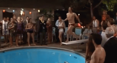 Man Diving Into Pool as Crowd Watches