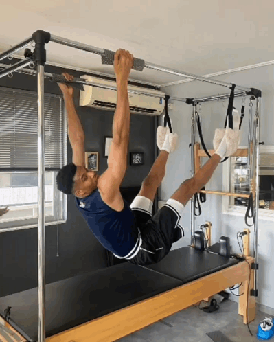 Man Doing Exercises on Pilates Machine
