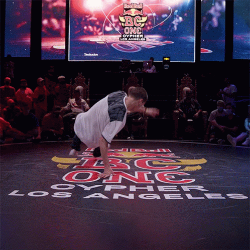 Man Doing Handstand In Front Of Red Bull Screen GIF