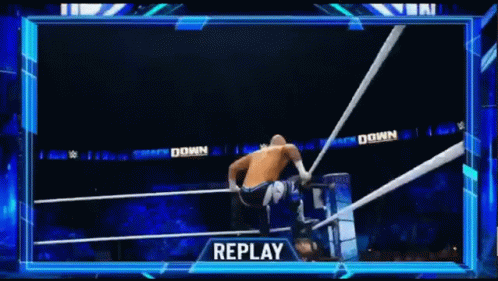 Man Doing Handstand in Wrestling Ring While Another Man Watches