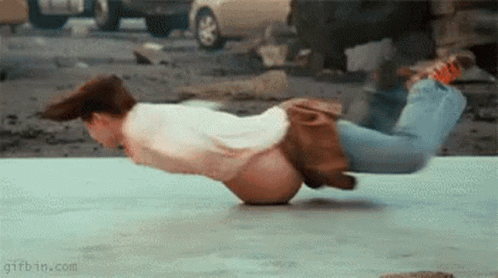 Man Doing Handstand with Car Background